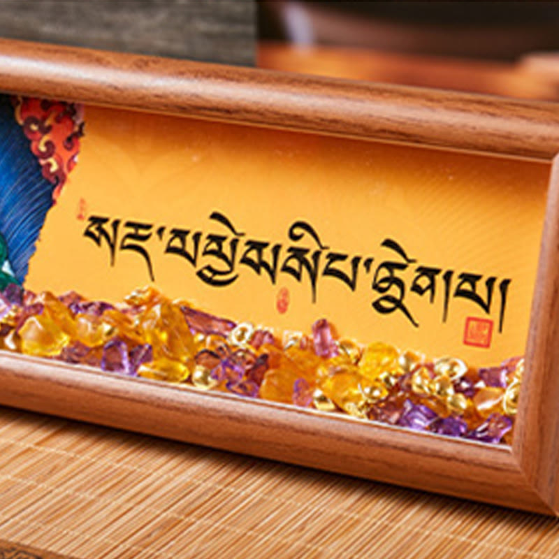 Detailed view of Tibetan calligraphy script on golden-yellow backing with purple and yellow crystal stone decorations