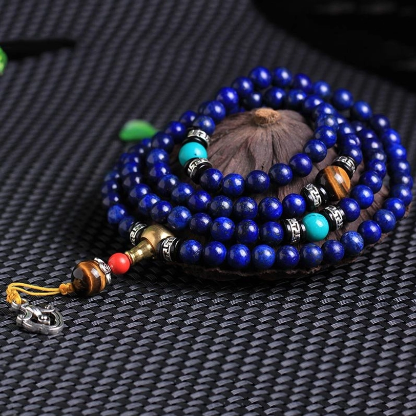 108-bead Lapis Lazuli mala necklace with golden tassel pendant flat lay presentation