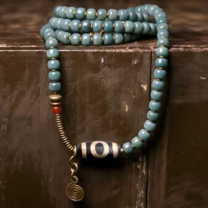 108 Bodhi Seed Tibetan Dzi Bead Mala Bracelet Nine-Eye Overhead Flat Lay with Brass Pendant