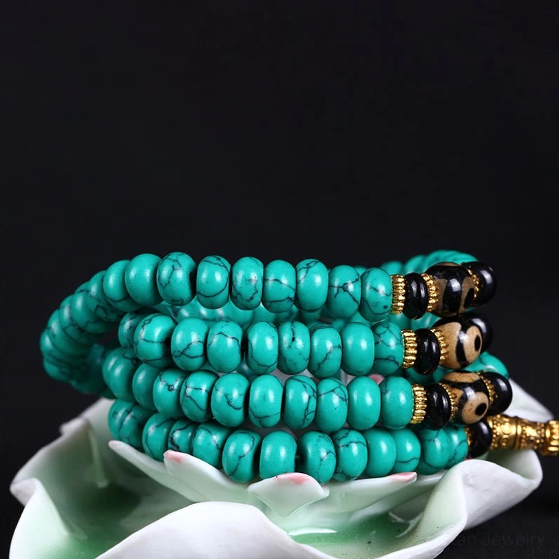 Stacked turquoise bead mala set displaying rounded beads with mixed gold and black decorative elements