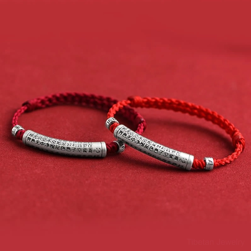 Close-up of 999 sterling silver Om Mani Padme Hum charm with intricate laser engraving of Buddhist mantra text