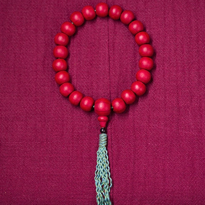 Abelia biflora wooden mala bracelet product lifestyle shot natural lighting sacred beads