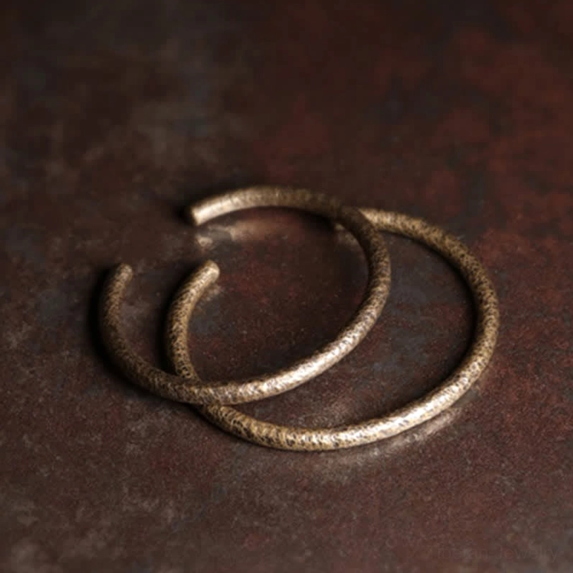 Adjustable open copper cuff bracelet with rustic hammered aesthetic and warm patina