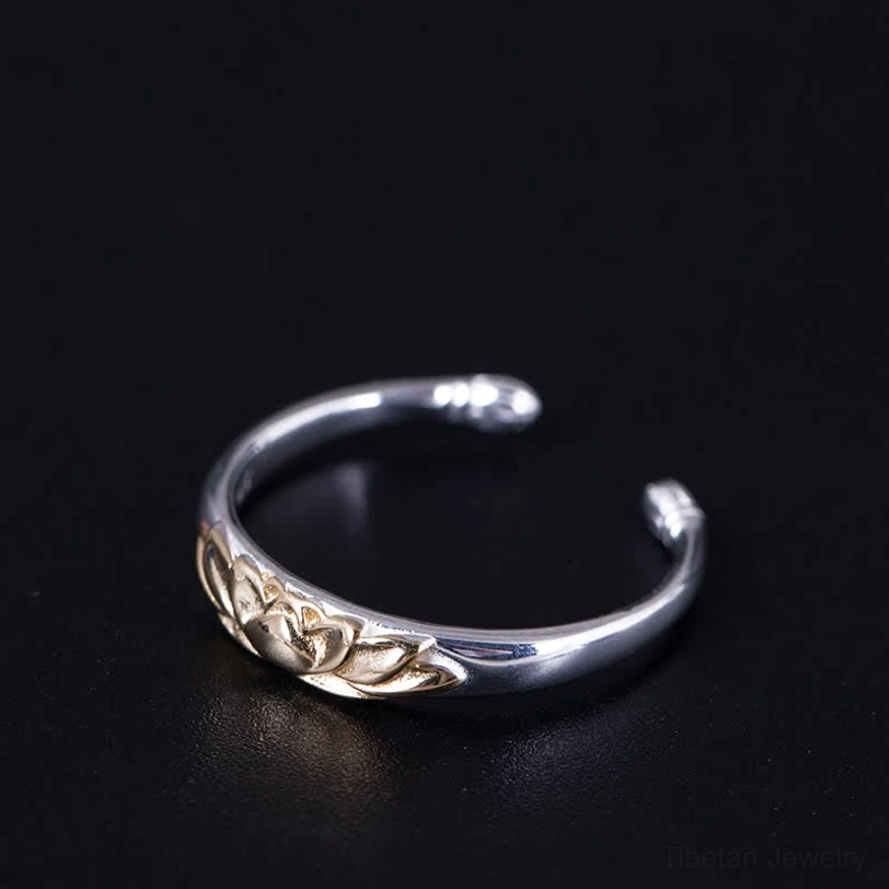 Adjustable lotus open ring side flat view showing slim silver band with gold lotus accent