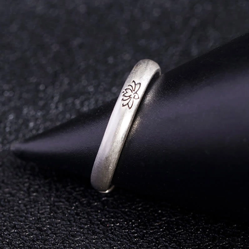 Matte silver lotus engraved adjustable ring side profile showing open band flexibility