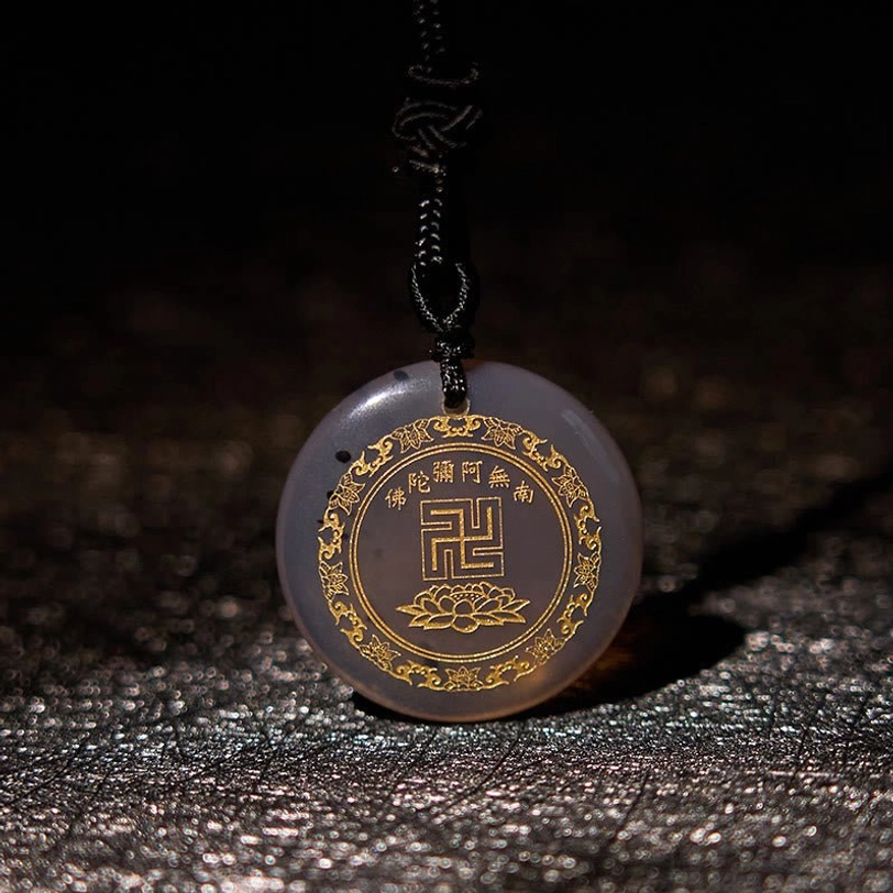 Agate Buddhist pendant necklace showing stone texture and engravings