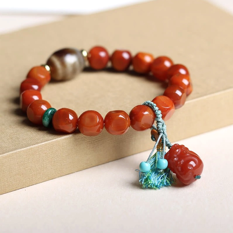 South Red Agate Pixiu Bracelet Detail - Close-Up Side View with Rounded Red Agate Beads, Green Spacer, Turquoise Tassel and Pixiu Pendant
