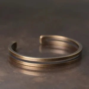 Handmade copper Viking cuff bracelet side view displaying open adjustable fit and antique bronze metallic finish