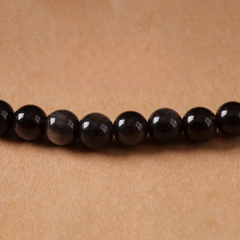 Authentic hand-woven Garuda Tibetan necklace with silver sheen obsidian beads and metal charm