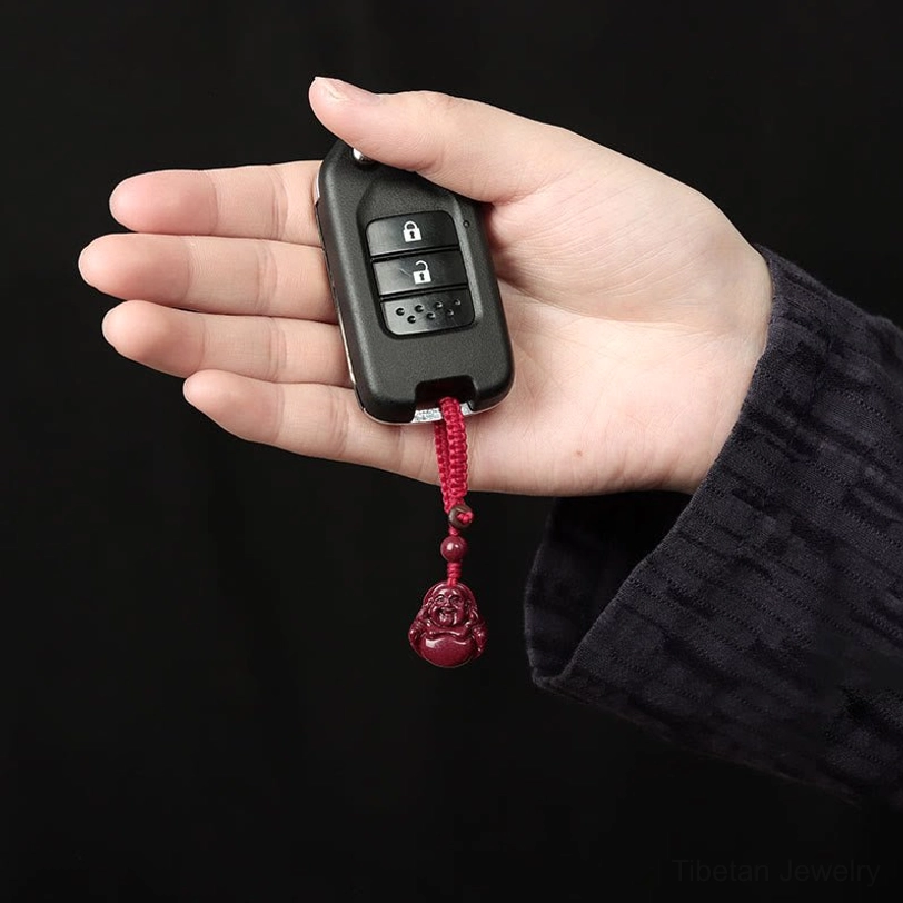 Authentic handcrafted cinnabar Buddha pendant showing natural stone texture and craftsmanship