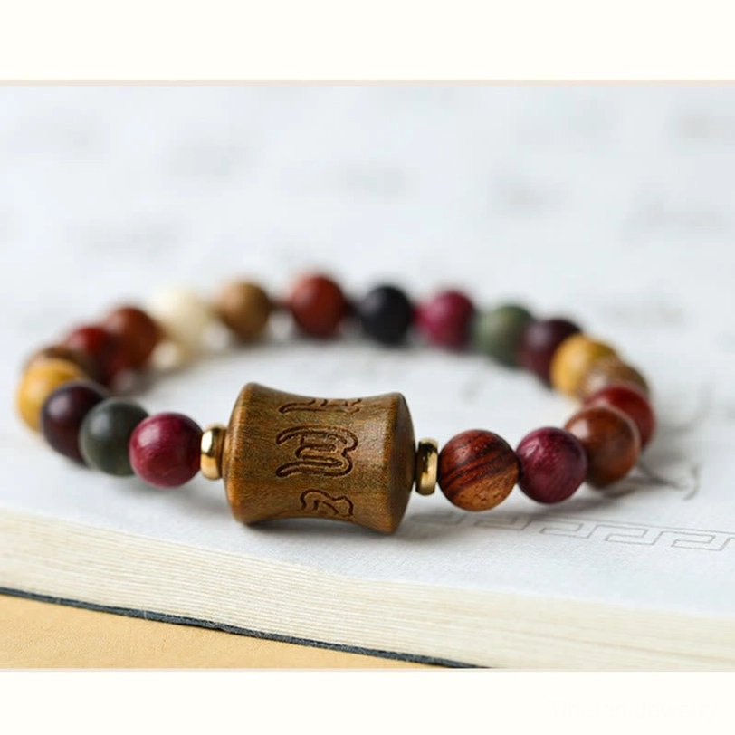 Authentic handmade Tibetan sandalwood protection bracelet with Om Mani Padme Hum mantra carved into central wooden bead