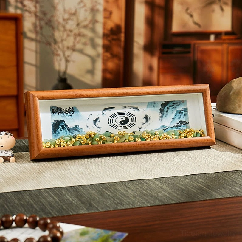 Front view of Bagua photo frame with central Yin Yang symbol, koi fish design, and green crystal accents on Chinese style desk