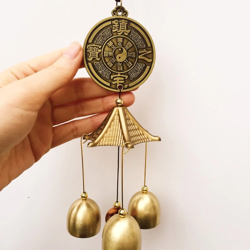 Bagua Yin-Yang wind chime with bronze medallion and three brass bells hand view