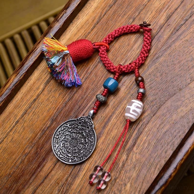 Beige Dzi bead Tibetan protective keychain with patterned stone, red rope, colorful tassel, silver Bagua charm