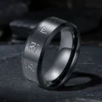Black Jambhala Mantra titanium steel ring with engraved Sanskrit mantras, three-quarter oblique view showcasing brushed matte black finish
