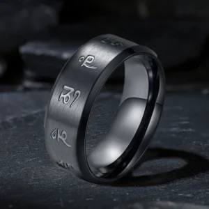 Black Jambhala Mantra titanium steel ring with engraved Sanskrit mantras, three-quarter oblique view showcasing brushed matte black finish