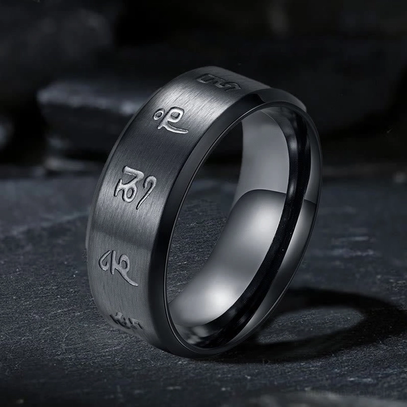 Black Jambhala Mantra titanium steel ring with engraved Sanskrit mantras, three-quarter oblique view showcasing brushed matte black finish