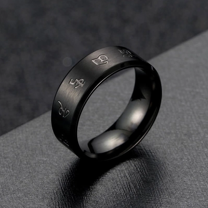 Black Jambhala Mantra titanium steel ring close-up side view, highlighting brushed surface texture and Sanskrit mantra engravings