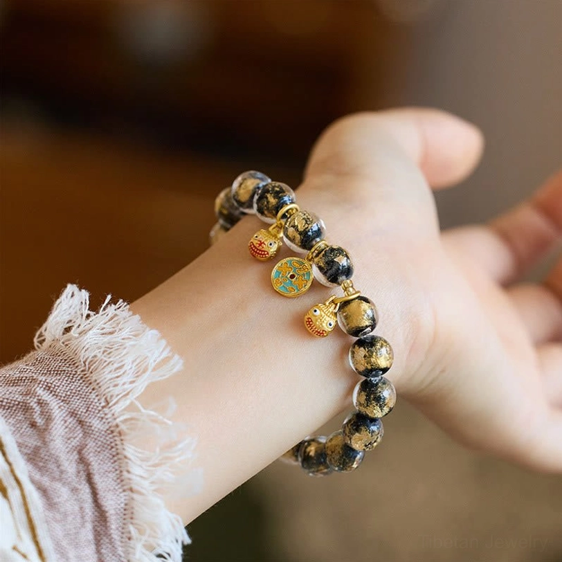 Black translucent liuli glass fortune bracelet with enamel Pi Xiu metal pendants and gold accents