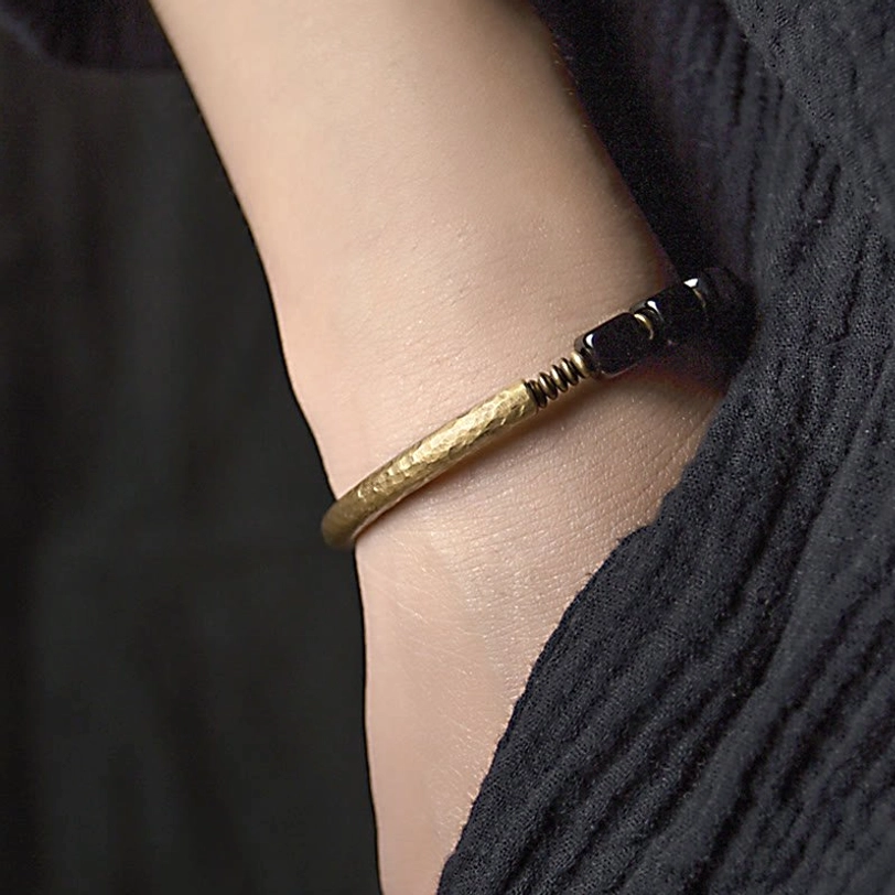 Black obsidian and copper couple bracelet styling guide, showing how to wear and layer with other accessories