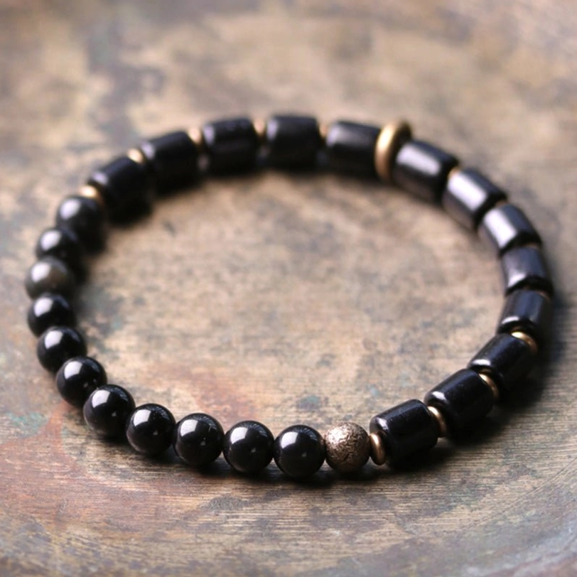 Black obsidian and ebony wood protective couple bracelet featuring dark volcanic glass beads with grounding energy