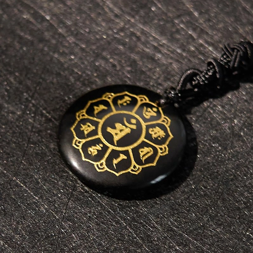 Black Obsidian Om Mani Padme Hum pendant side view showing lotus engraving and braided rope detail