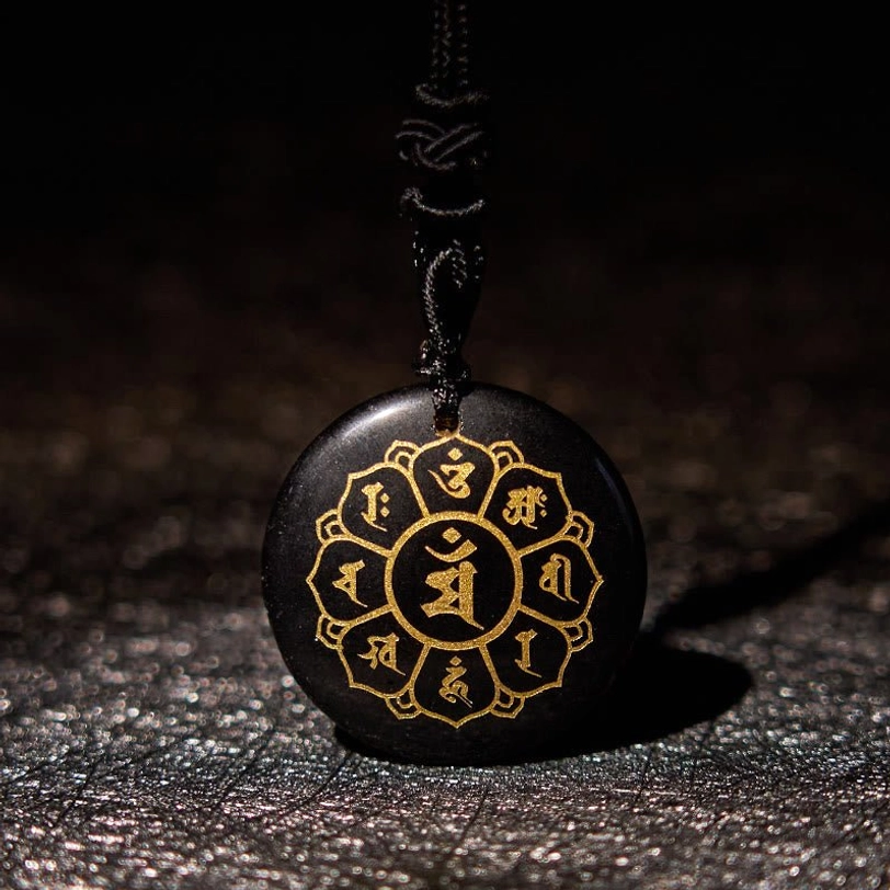 Black Obsidian Om Mani Padme Hum mantra pendant necklace with golden Sanskrit engravings and black braided rope