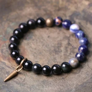 Black Obsidian and blue Sodalite couple bracelet with copper spike clasp on wooden background - natural stone healing bracelet