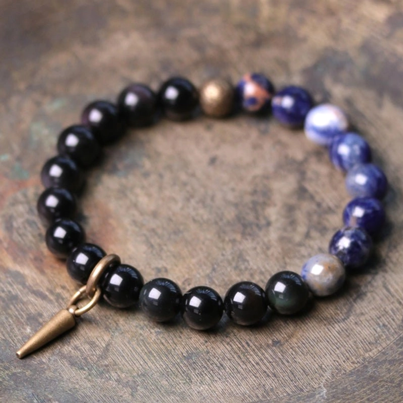 Black Obsidian and blue Sodalite couple bracelet with copper spike clasp on wooden background - natural stone healing bracelet