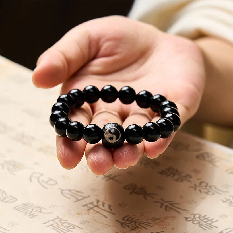 Black Obsidian Yin Yang beaded protection bracelet detail shot, handcrafted natural stone beads with spiritual symbols