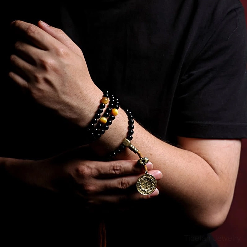 Black onyx mala bracelet meditation tool showing all 108 sacred beads arranged in complete circle on neutral background