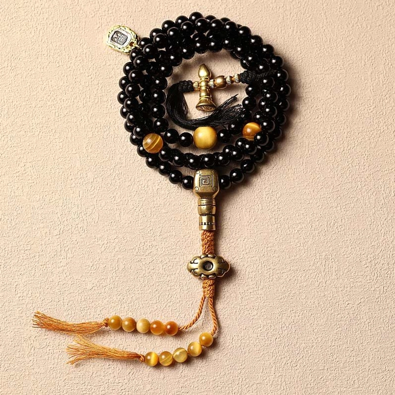 Black onyx and copper tibetan mala bracelet in both 6mm and 8mm bead size options showing size comparison