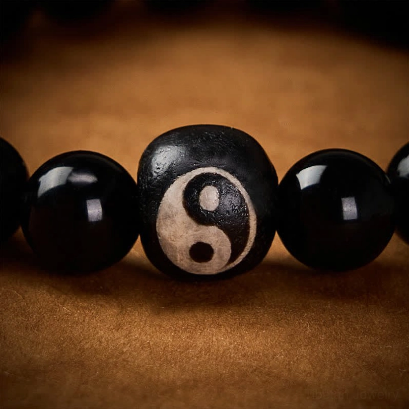 Black Onyx and Obsidian Yin Yang bracelet full view, premium elastic string beads with engraved balance symbol