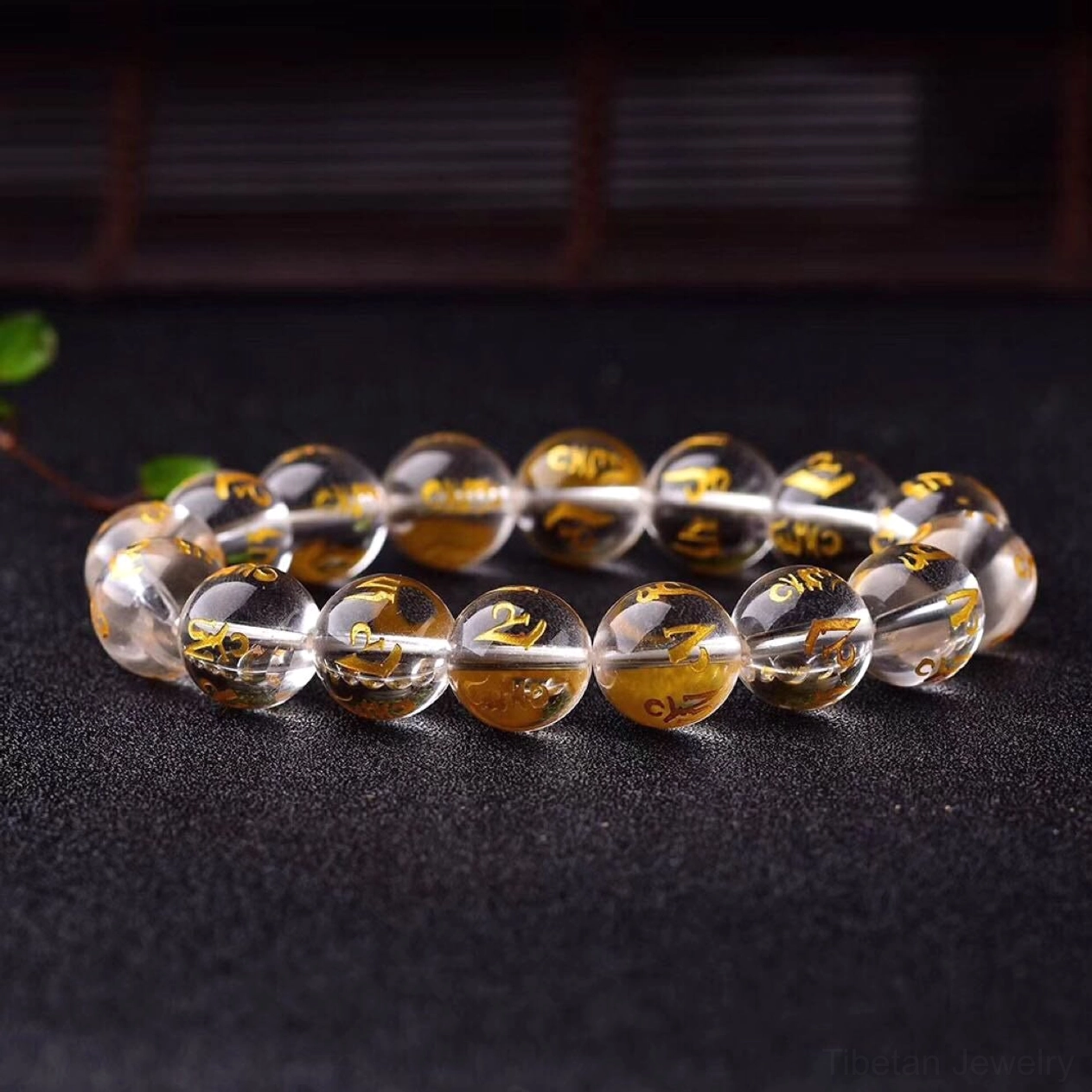 Black onyx protection bracelet with fortune meaning displayed on wooden jewelry display stand