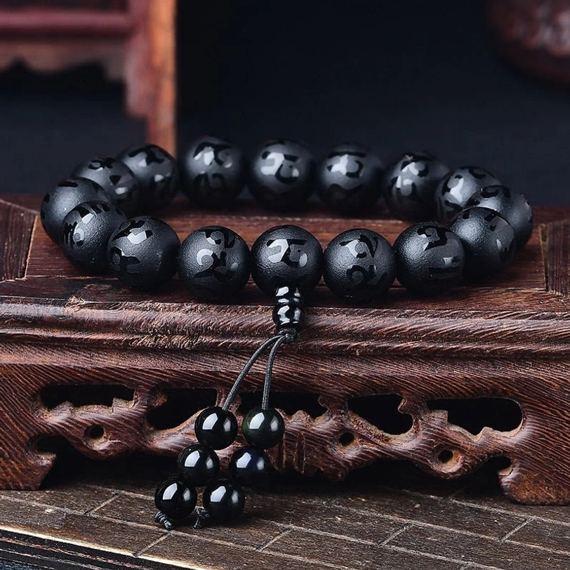 Black onyx Tibetan meditation bracelet with engraved Om Mani Padme Hum mantra beads and gold hardware