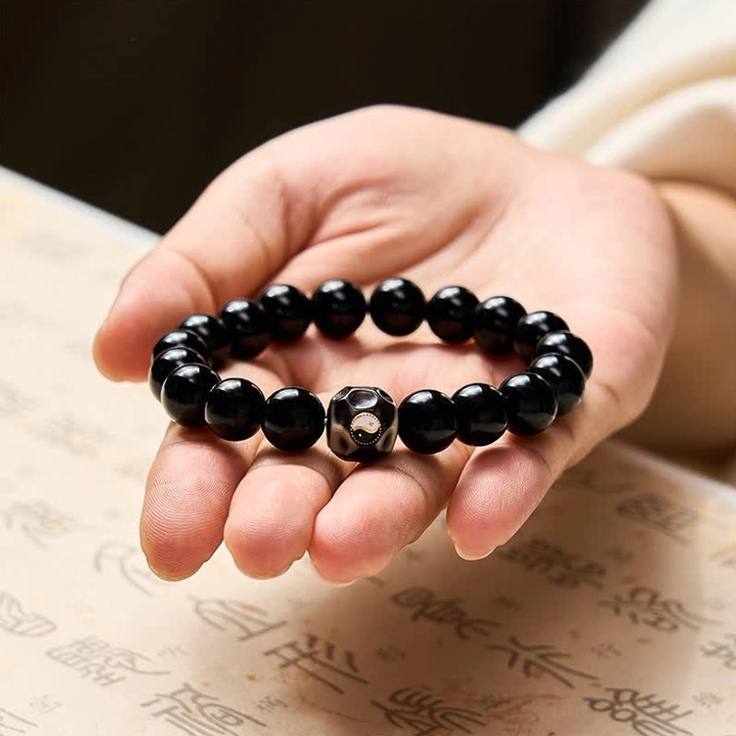 Black Onyx Yin Yang balance bracelet close-up showing bead texture and elastic string construction
