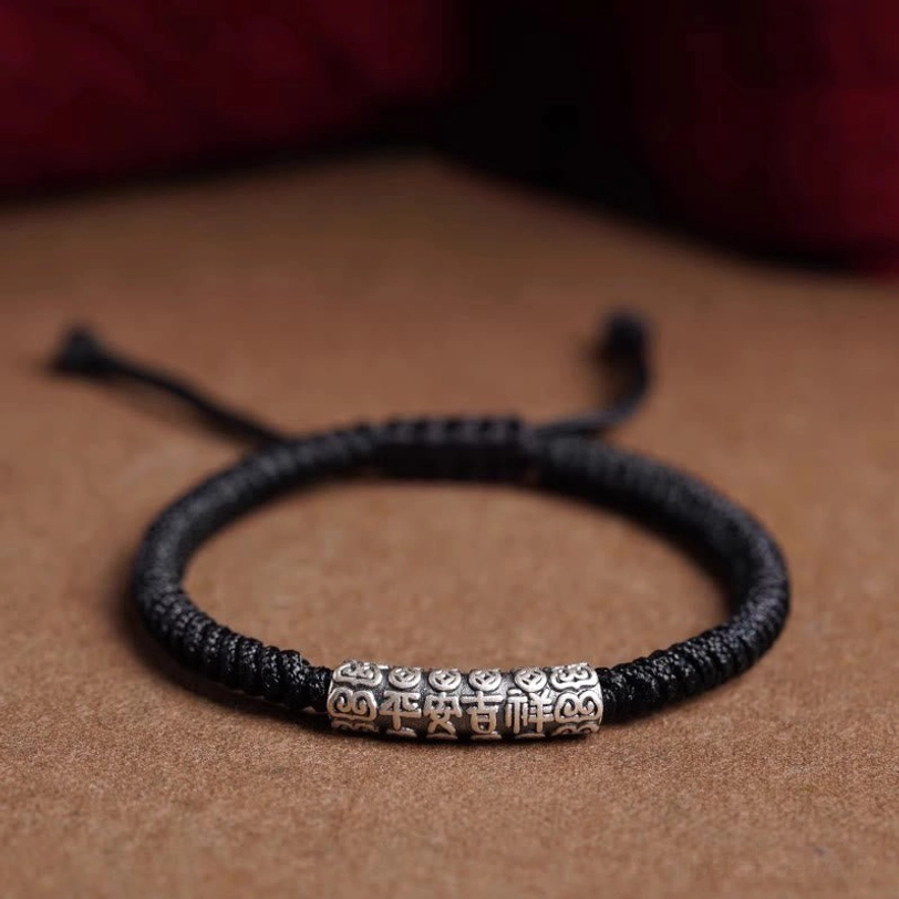 Black Tibetan protection rope bracelet with engraved peace and good fortune silver charm, spiritual energy wristband