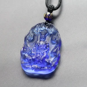 Deep blue Ksitigarbha Buddha Liuli crystal pendant with flame carved border, seated Bodhisattva holding staff, black braided cord with blue bead accent