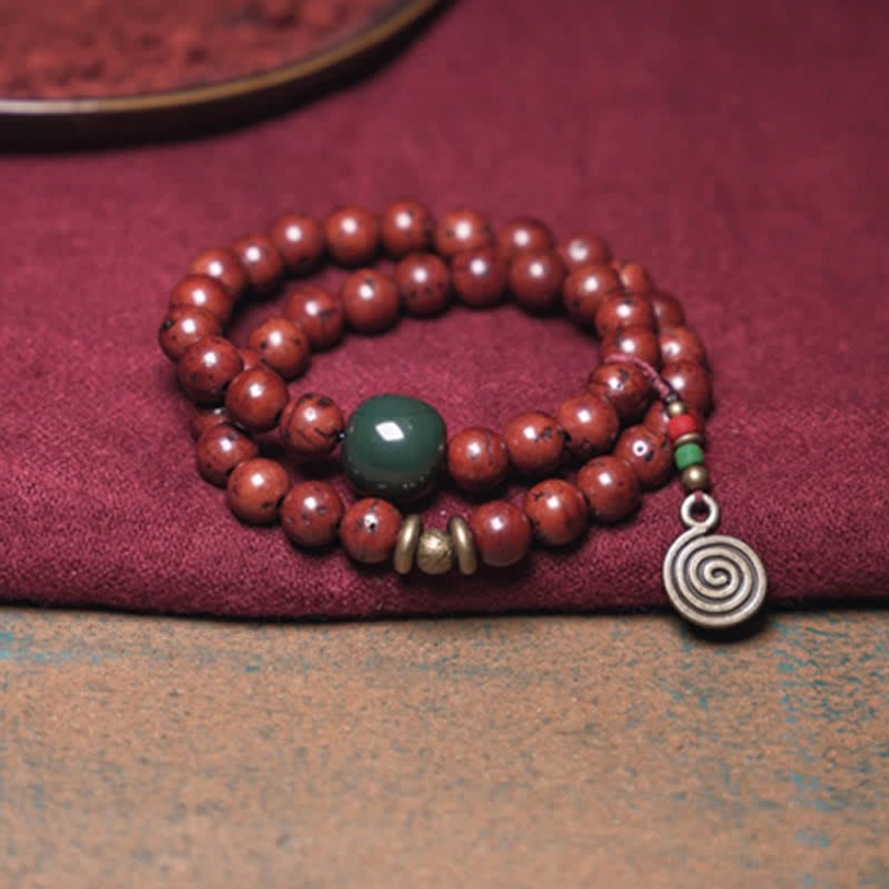 Tibetan bodhi seed bracelet with brass spacers green jade bead and spiral charm pendant