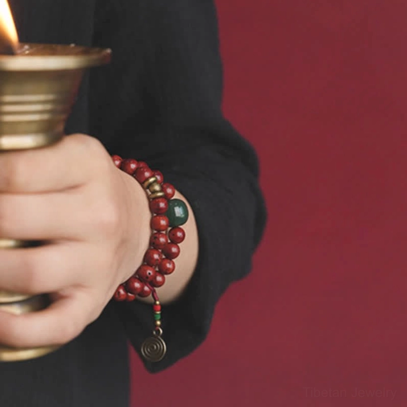 Spiritual meditation bracelet on hand holding candle lamp demonstrating layered wear style