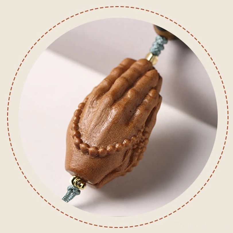 Bodhi seed bracelet with three-eye Dzi bead and Buddha hand charm flat lay arrangement