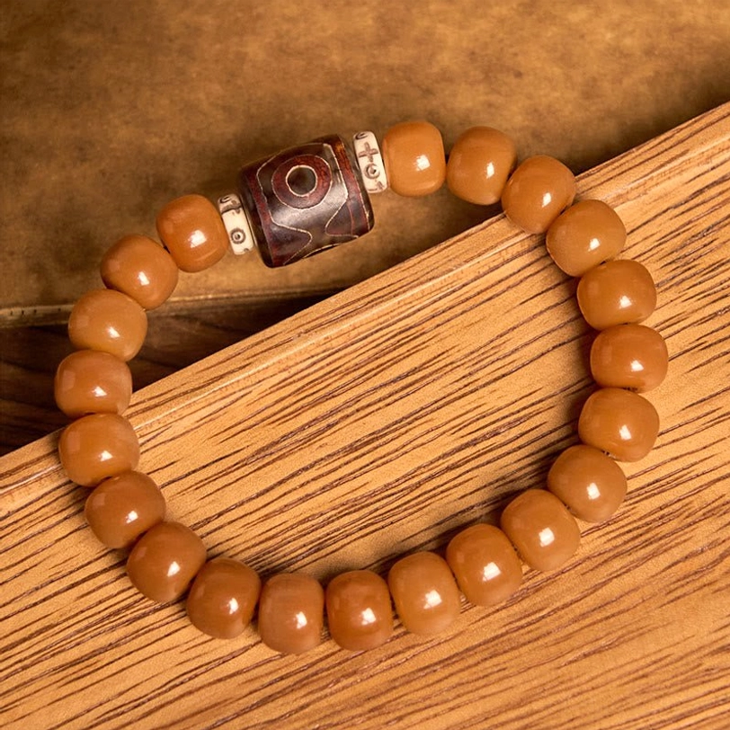 Bodhi and Dzi bead protection bracelet overhead view - showing detailed bead texture and metal spacer accents