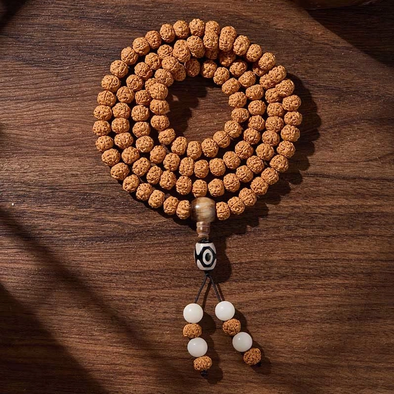 Bodhi seed mala necklace with dzi bead accents, displaying natural stone materials and traditional Tibetan spiritual jewelry craftsmanship