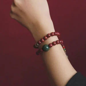 Bodhi seed jade bracelet worn on wrist showing double wrap style with green accent bead and copper spacers