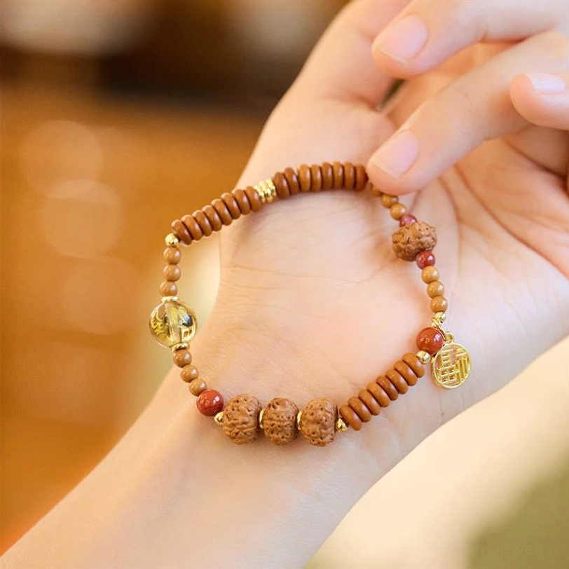 Tibetan bodhi seed bracelet with smoky quartz and olive pit beads, circular handheld display