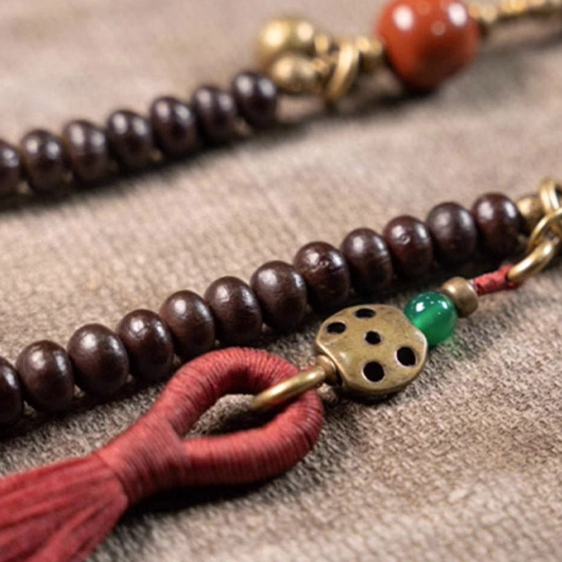 Close-up macro detail of purple bodhi seed beads showing natural texture and polish
