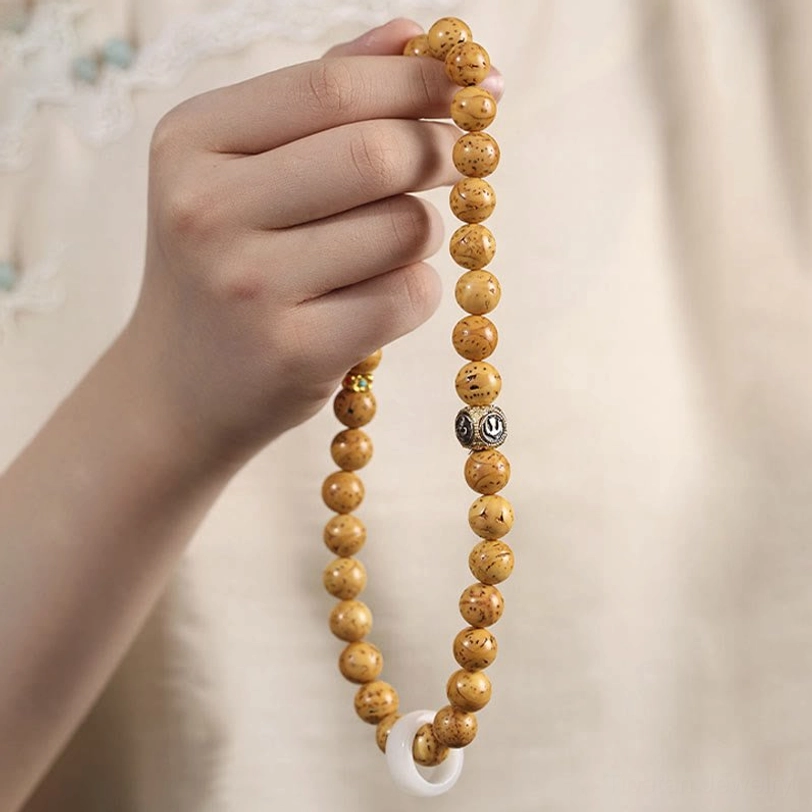 Sacred Bodhi seed beads close-up displaying traditional speckled pattern and spiritual significance