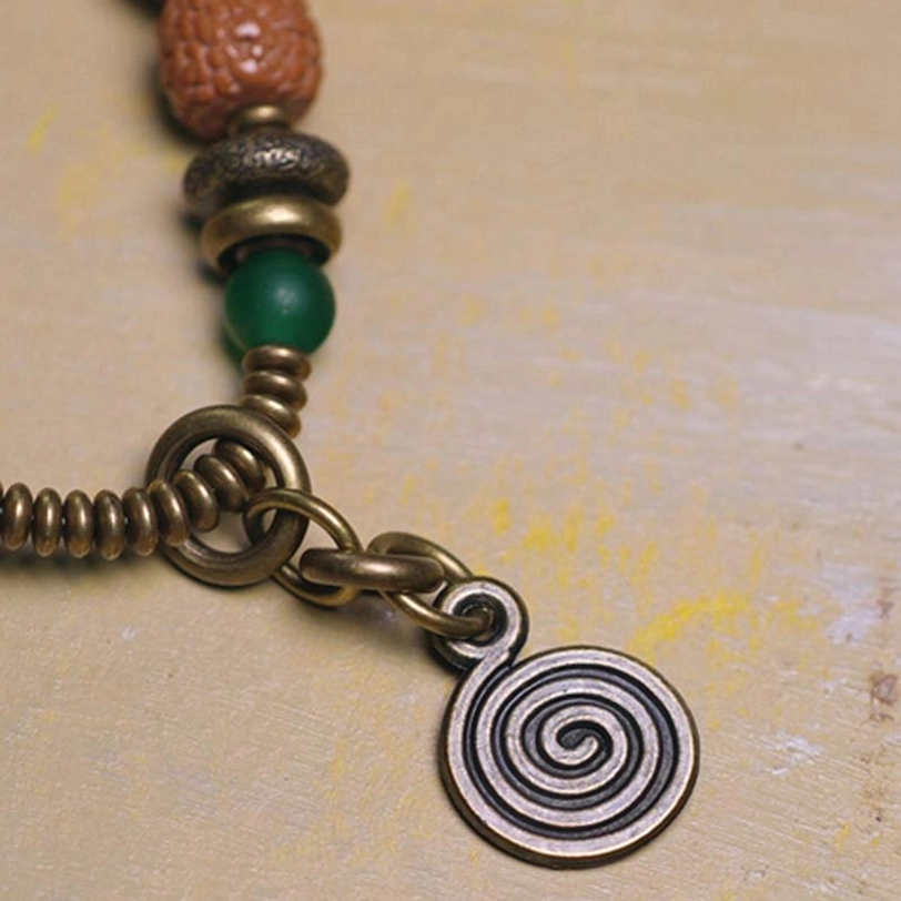Bodhi Seed beads from sacred Bodhi tree with natural dark speckles symbolizing enlightenment and Buddhist spiritual awakening