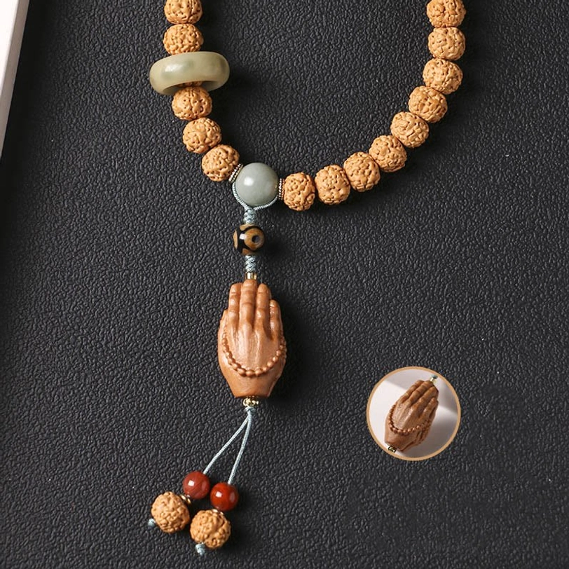 Single-loop Bodhi seed bracelet with jade ring, three-eye Dzi bead, and Buddha hand tassel close-up detail view