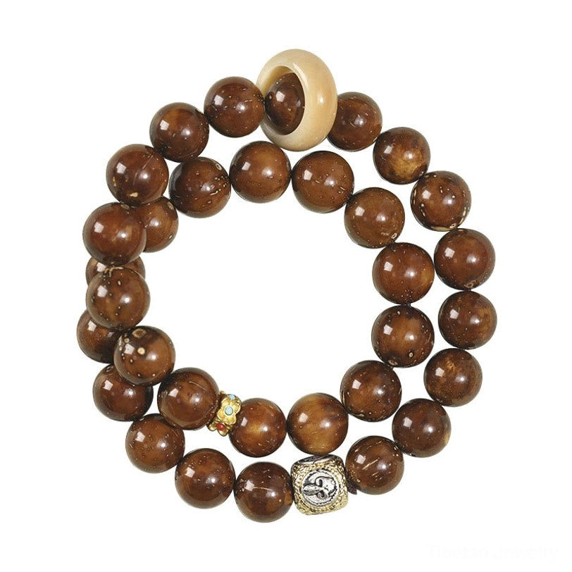 Natural Bodhi seed double wrap bracelet with dark brown round beads and silver decorative metal charm on light surface